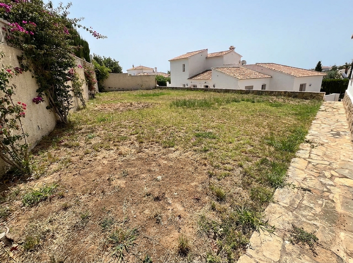 Villa backyard in Calahonda before landscaping — tired patchy natural lawn