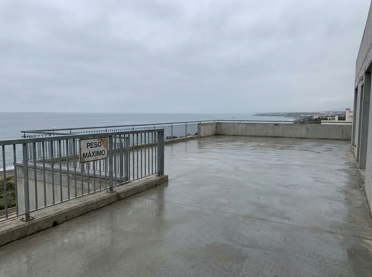 Apartment terrace in Cancelada before landscaping — bare concrete, sea view